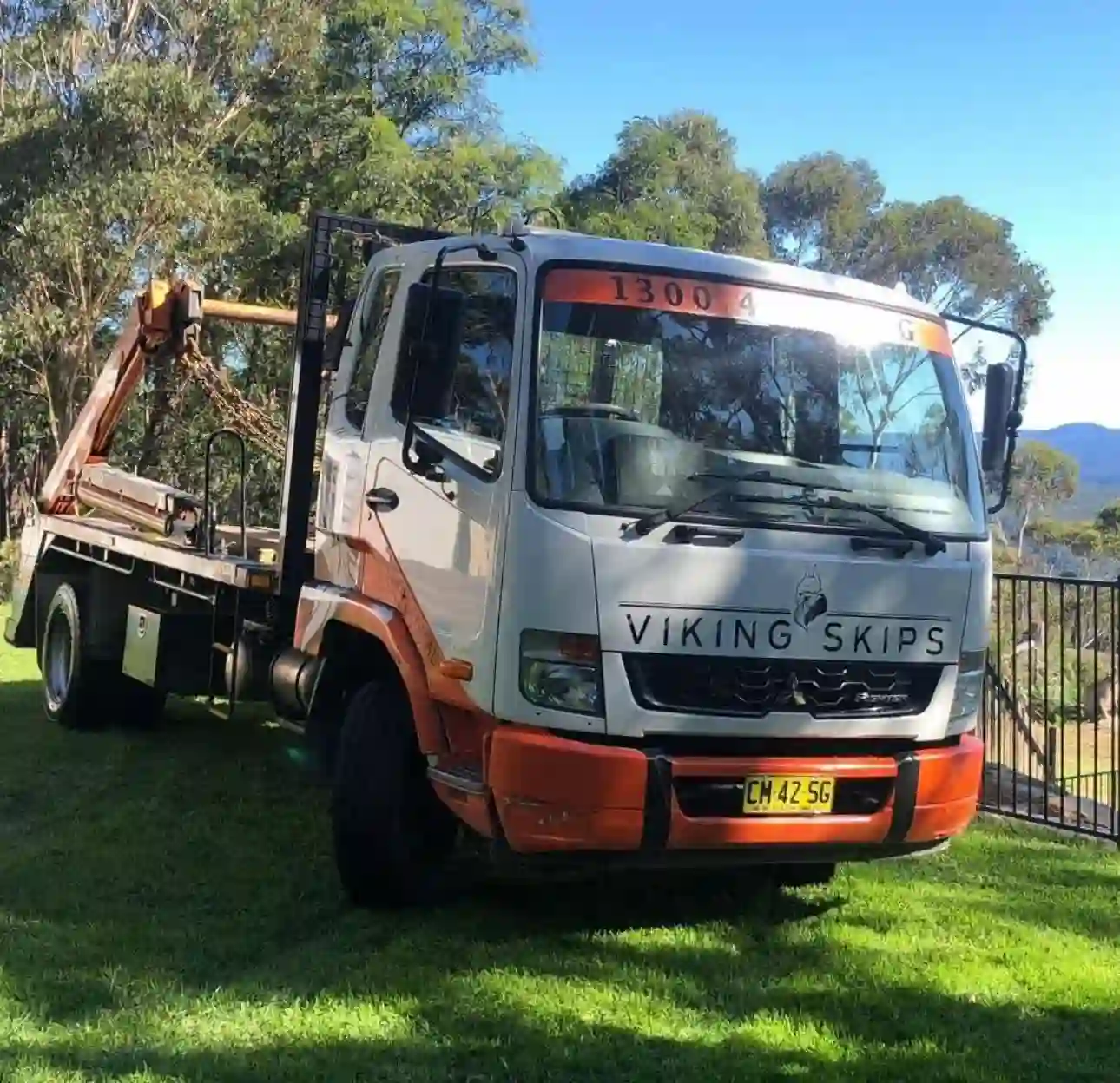 Orange Viking skip bin placed on a residential driveway