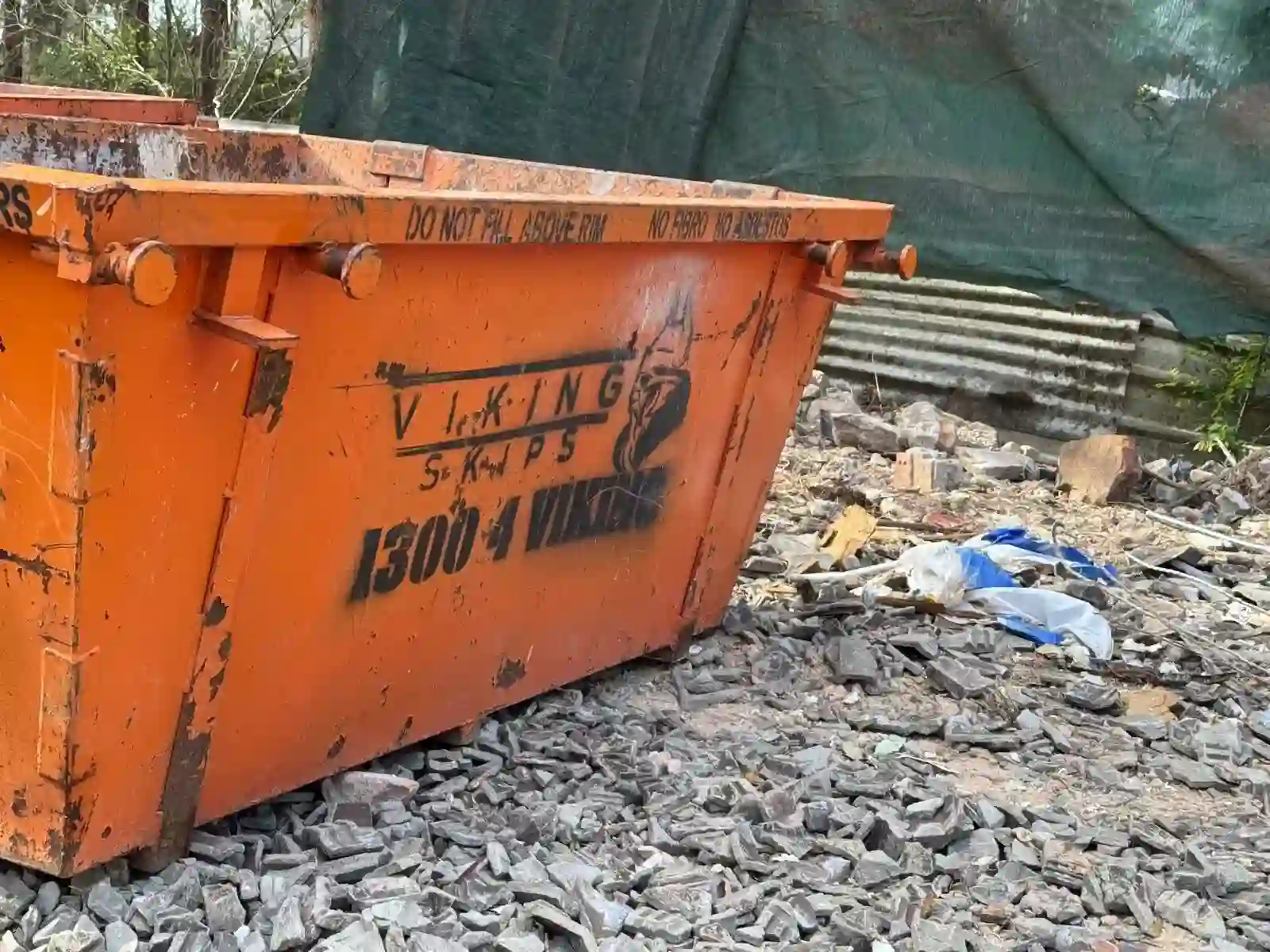 Viking Skips hook truck lifting a loaded skip bin